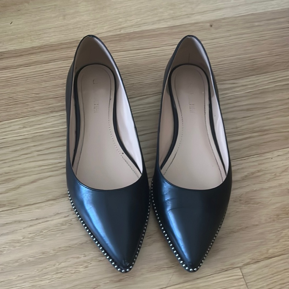 Black leather Coach flats